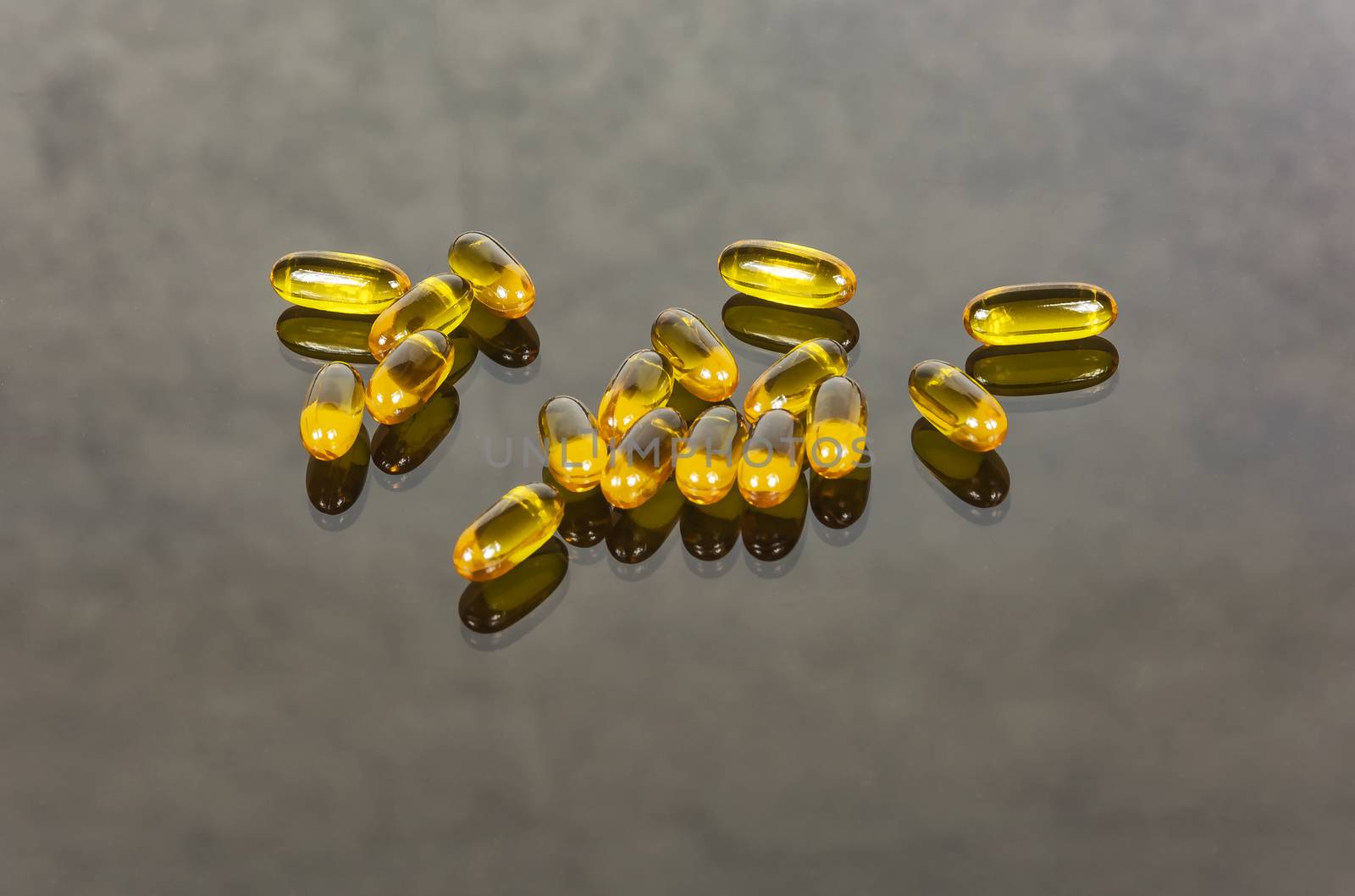 Capsules with medicine lie on a glass surface