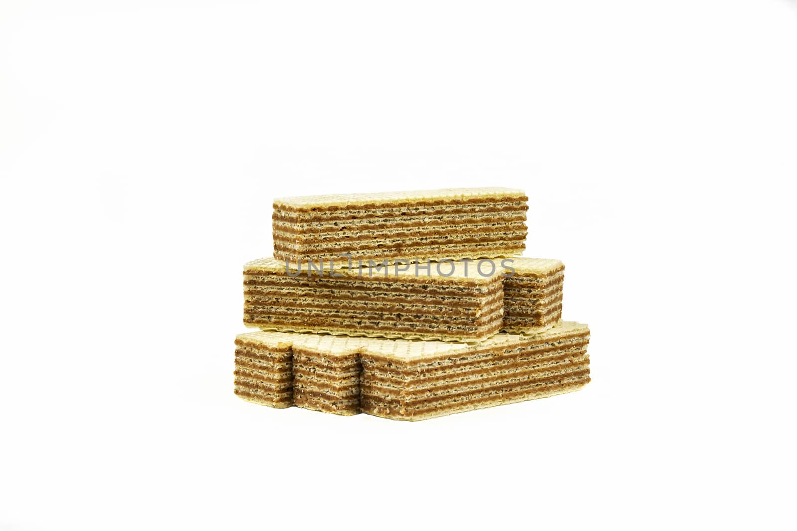 Several strips of waffle dessert with chocolate filling lie on a light background