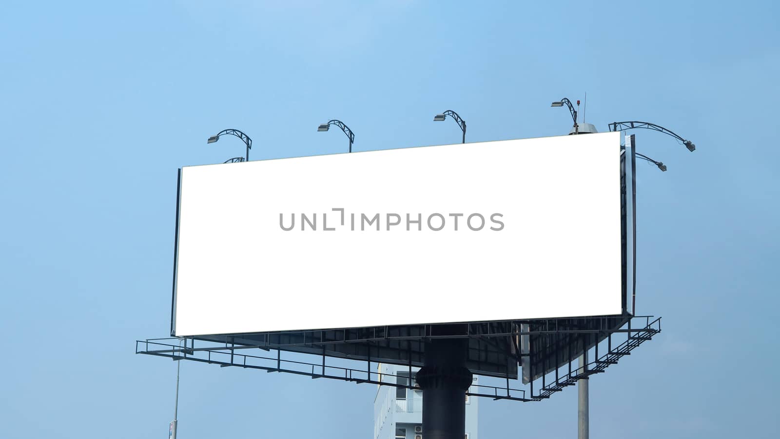 Blank billboard large size for outdoor or out of home advertising with blue sky.