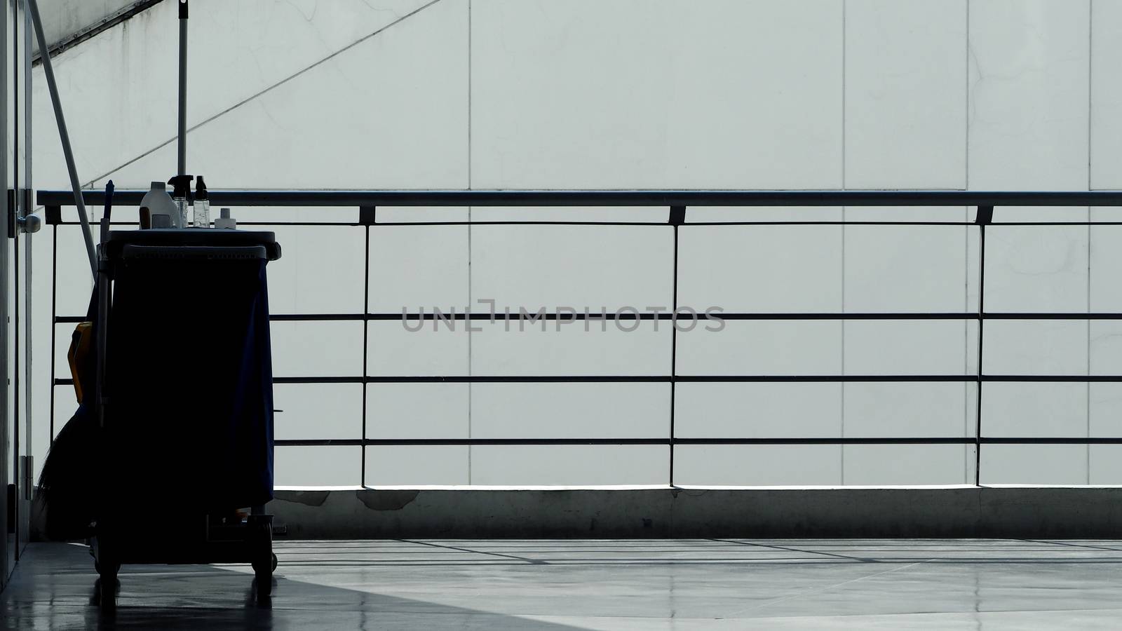 Silhouette of cleaning service people sweeping floor  by gnepphoto