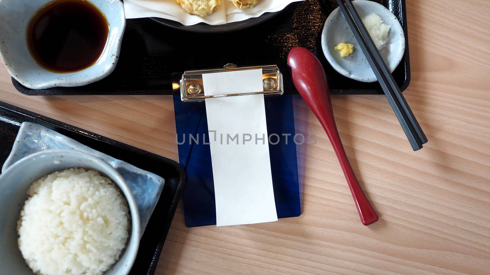 Blank receipt paper bill on the table. by gnepphoto