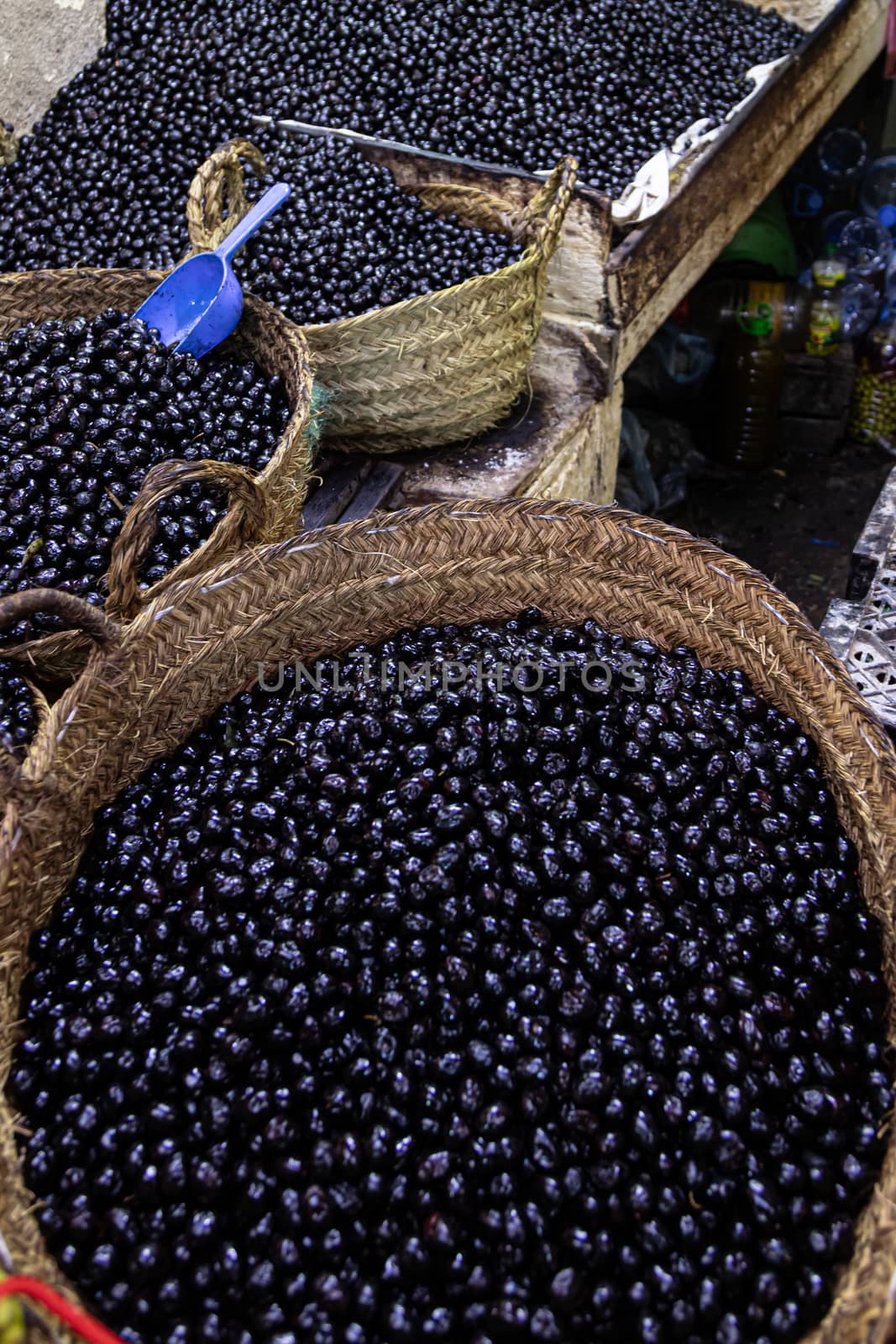 Marrakech, Morocco, 01/12/2020 market stall in the souk or market with baskets of black olives . High quality photo