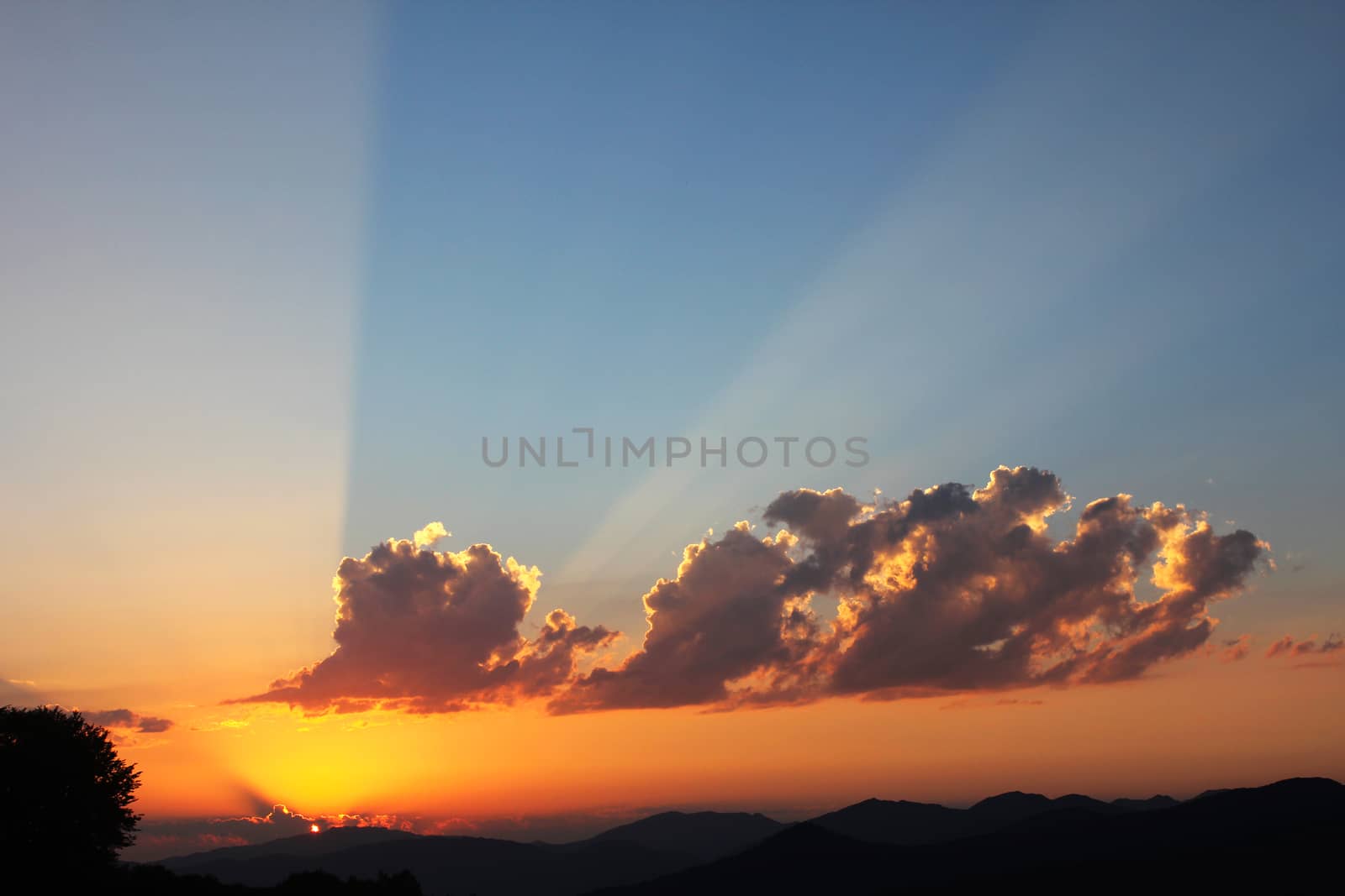 Mountain cloudscape and landscape at sunset in Georgia. Horizon in mountain range.cloudy vivid sunlight, fire storm cloudy view.