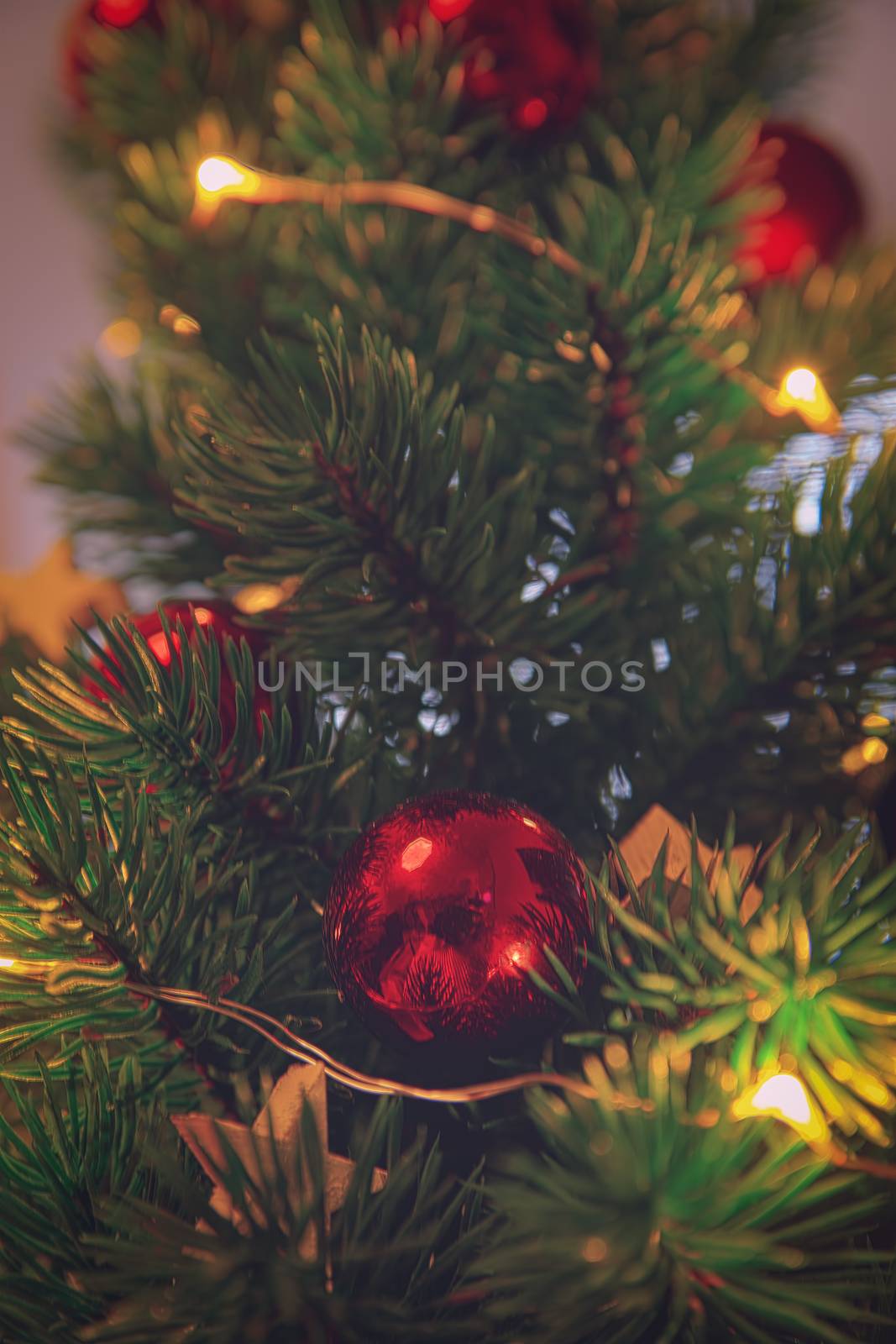 Close up of a Christmas tree with decoration. Red ornament on a Christmas tree with bokeh. Christmas, winter, new year concept.