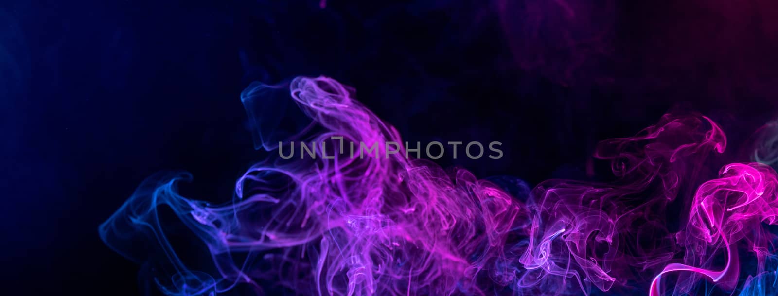 Conceptual image of colorful red and blue color smoke isolated on dark black background, Halloween concept design element.