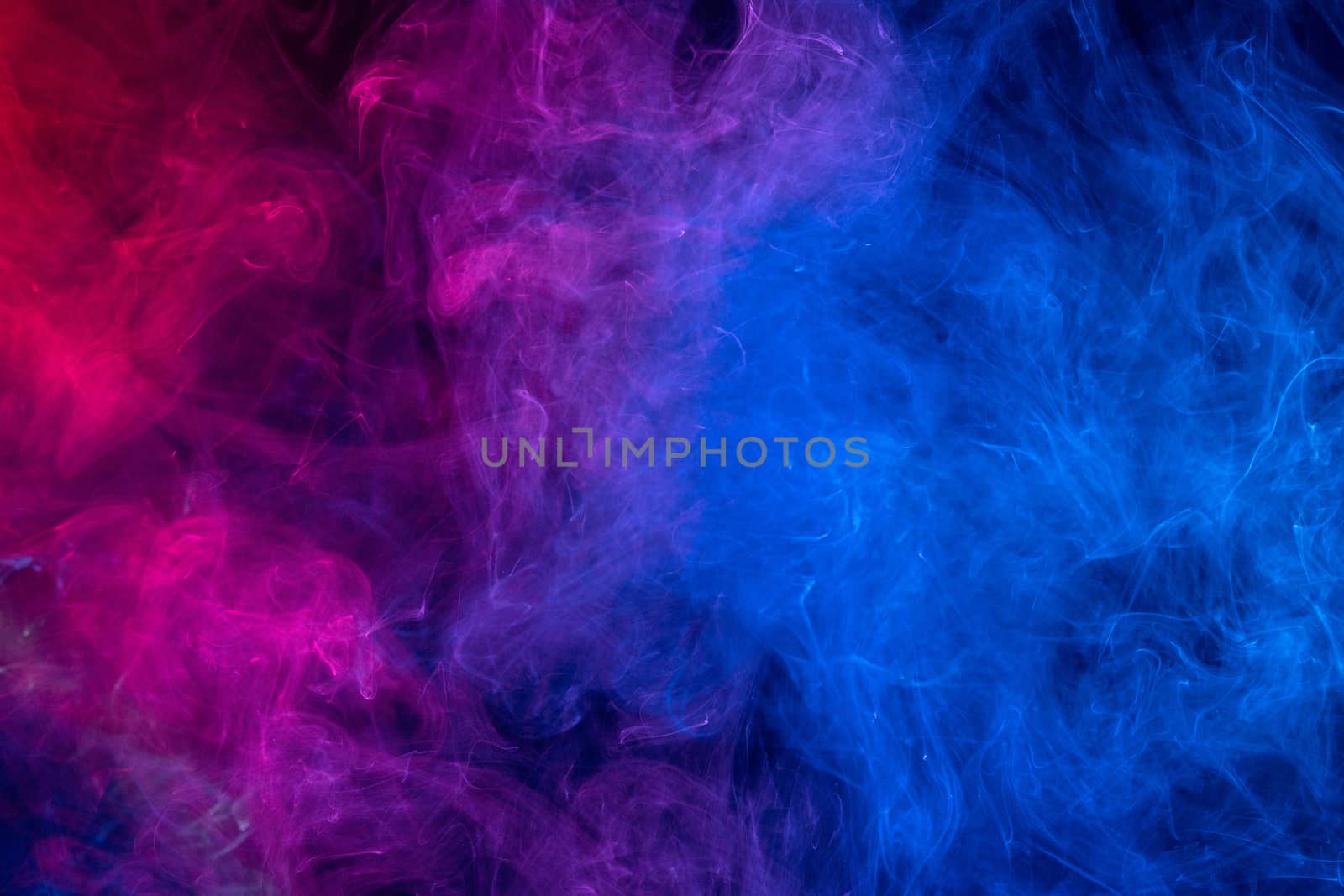 Conceptual image of colorful red and blue color smoke isolated on dark black background, Halloween concept design element.