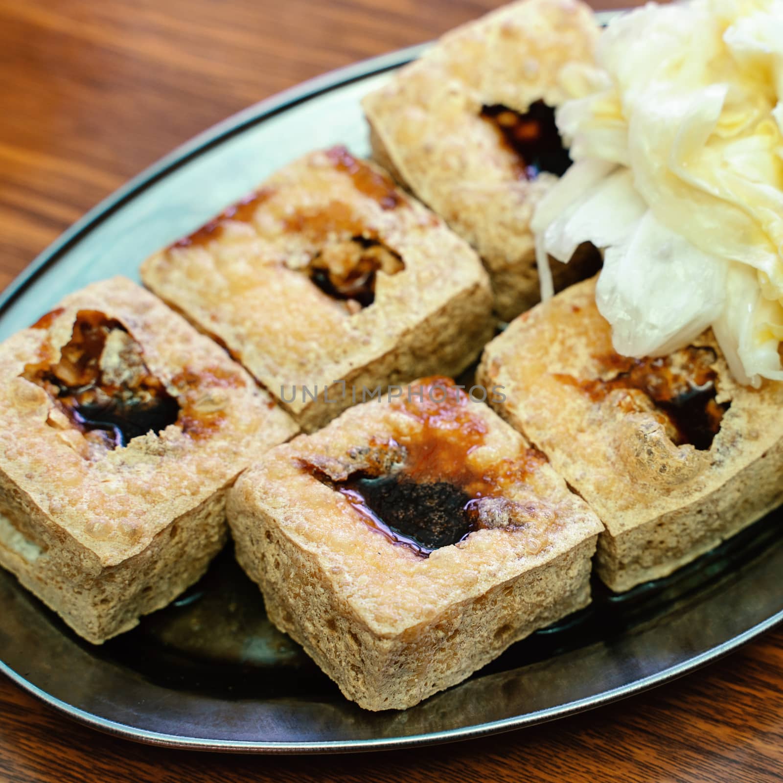 Deep fried stinky tofu, fermented bean curd with pickled cabbage vegetable, famous and delicious street food in Taiwan, lifestyle.