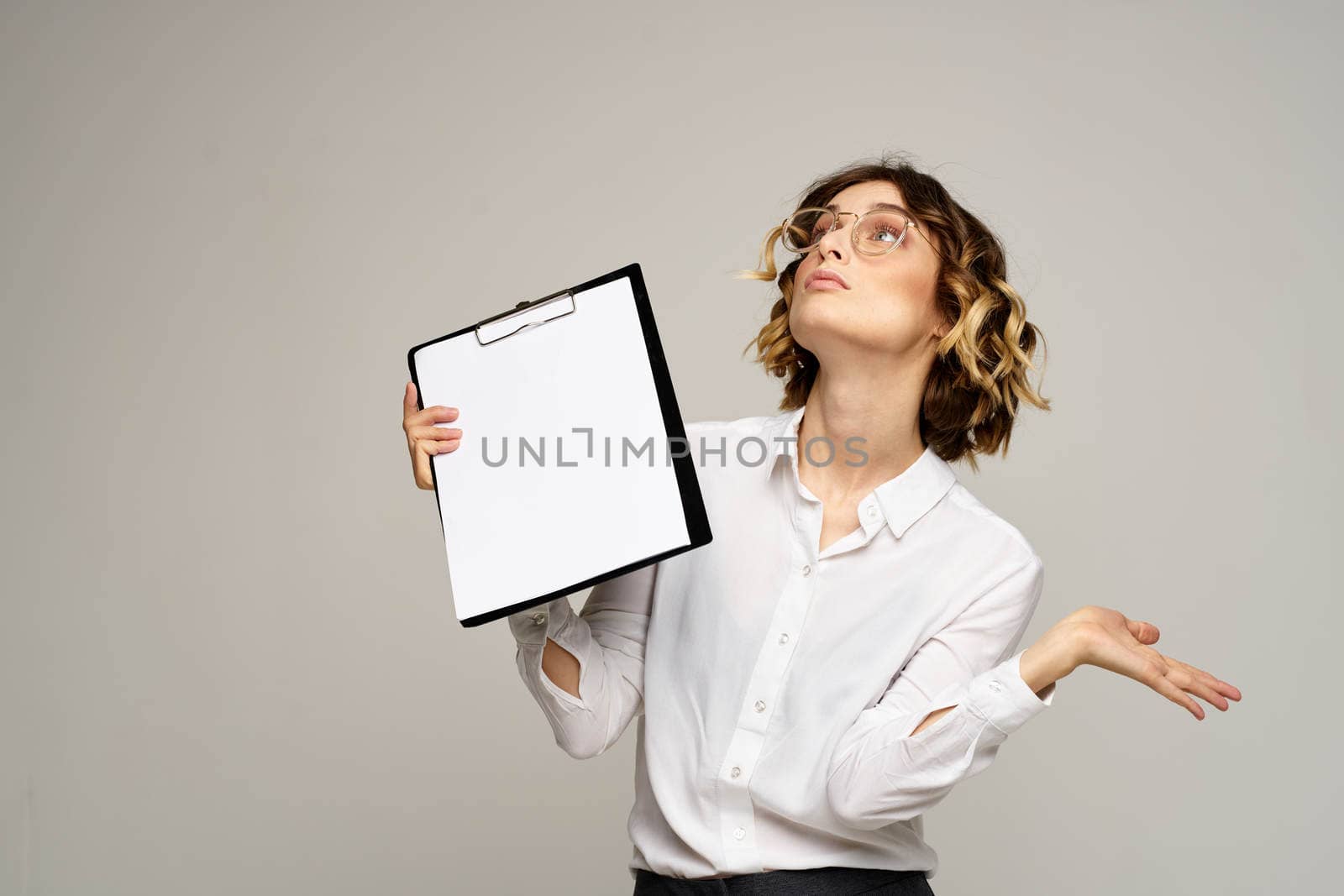 Business woman with folder of documents in hands on gray background cropped view of work. High quality photo