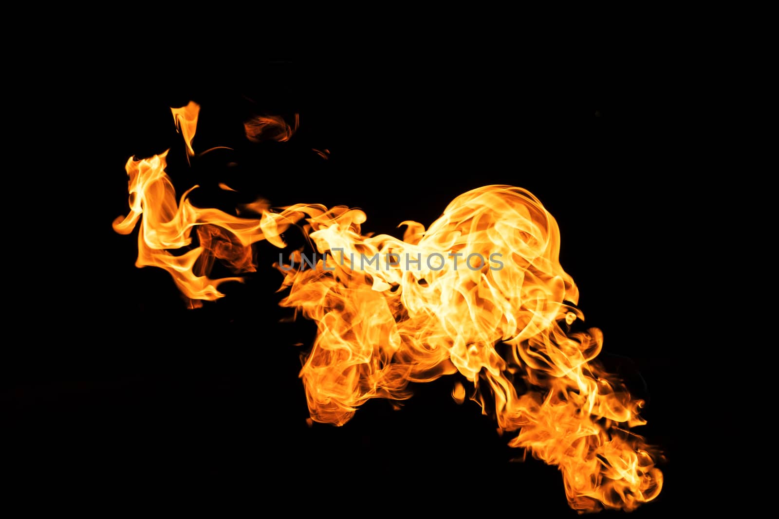 Fire flames on black background isolated. Burning gas or gasoline burns with fire and flames. Flaming burning sparks close-up, fire patterns. Infernal glow of fire in the dark with copy-space