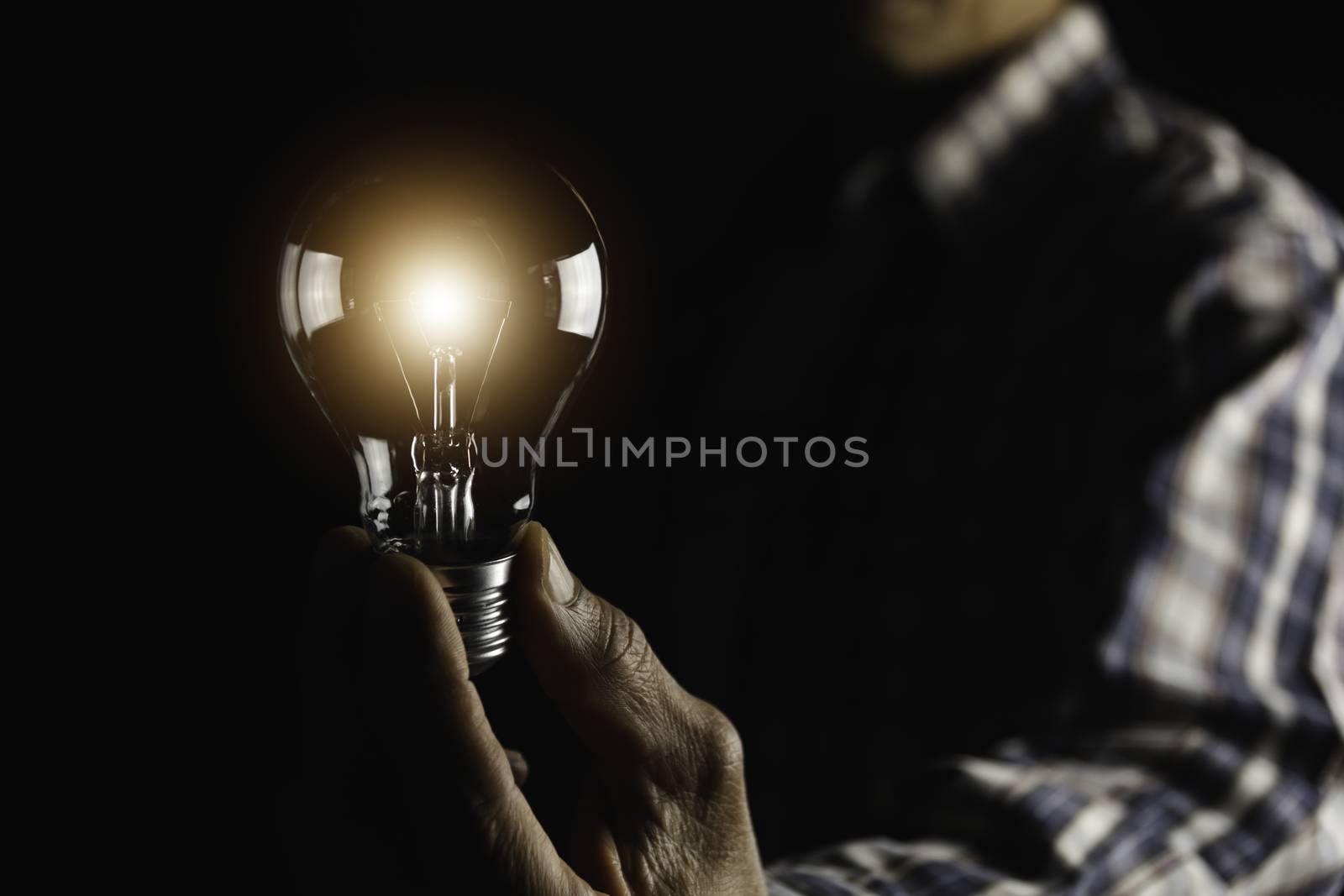 Hand holding a light bulb. Innovation and creative concept. by kirisa99