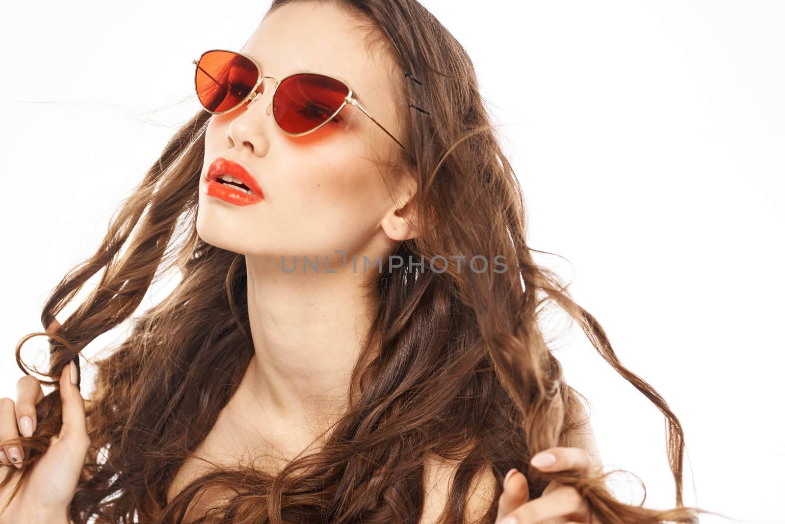 Portrait of brunette woman in sunglasses naked shoulders light background by SHOTPRIME