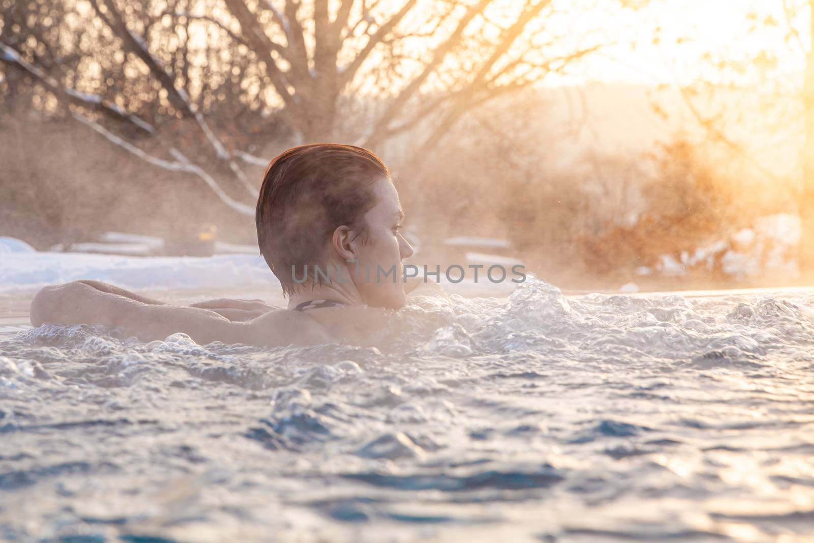 winter pool with a young attractive relaxing woman.