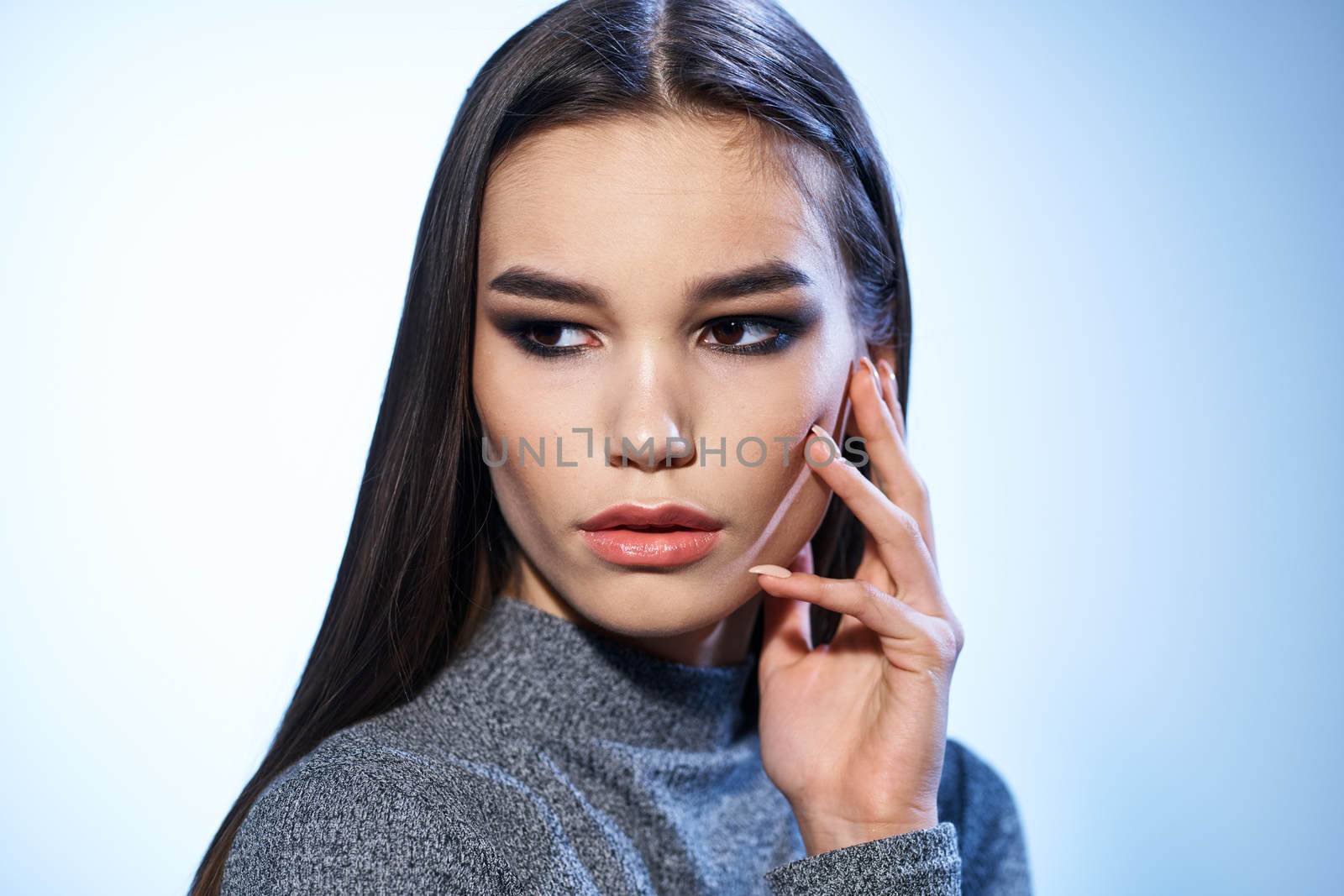 Pretty woman in gray sweater bright makeup long hair charm cropped view by SHOTPRIME