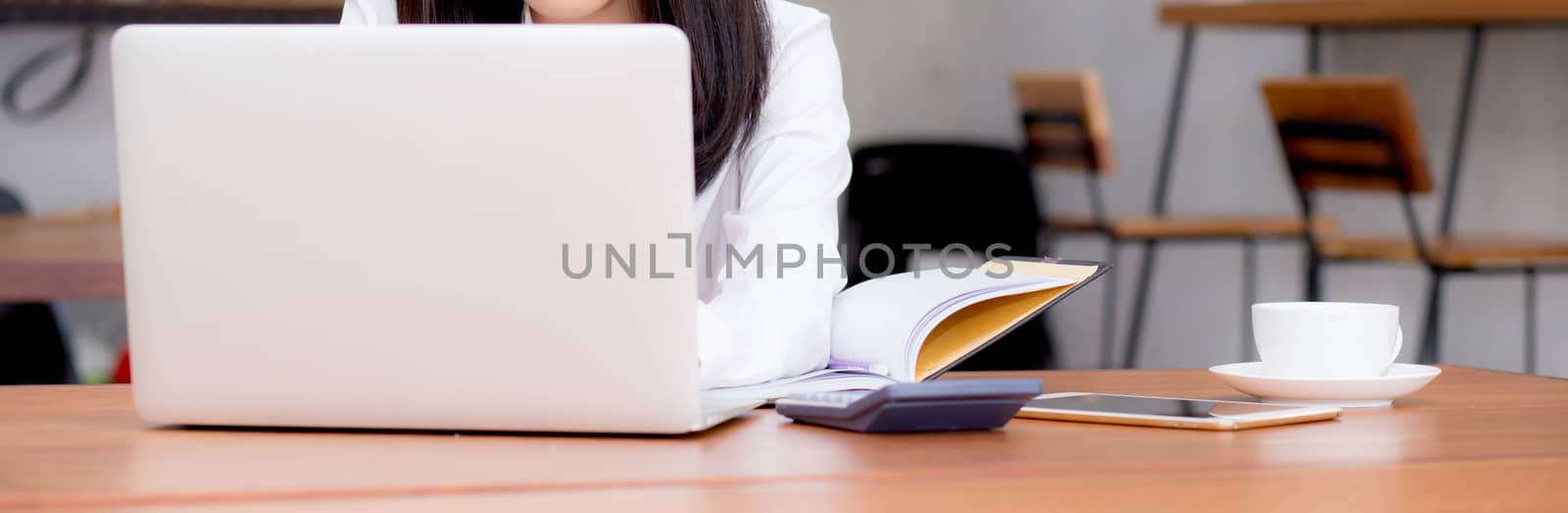 Closeup banner asian young woman working online on laptop sitting at coffee shop, professional female freelancer using notebook computer with connect to internet for distance job.