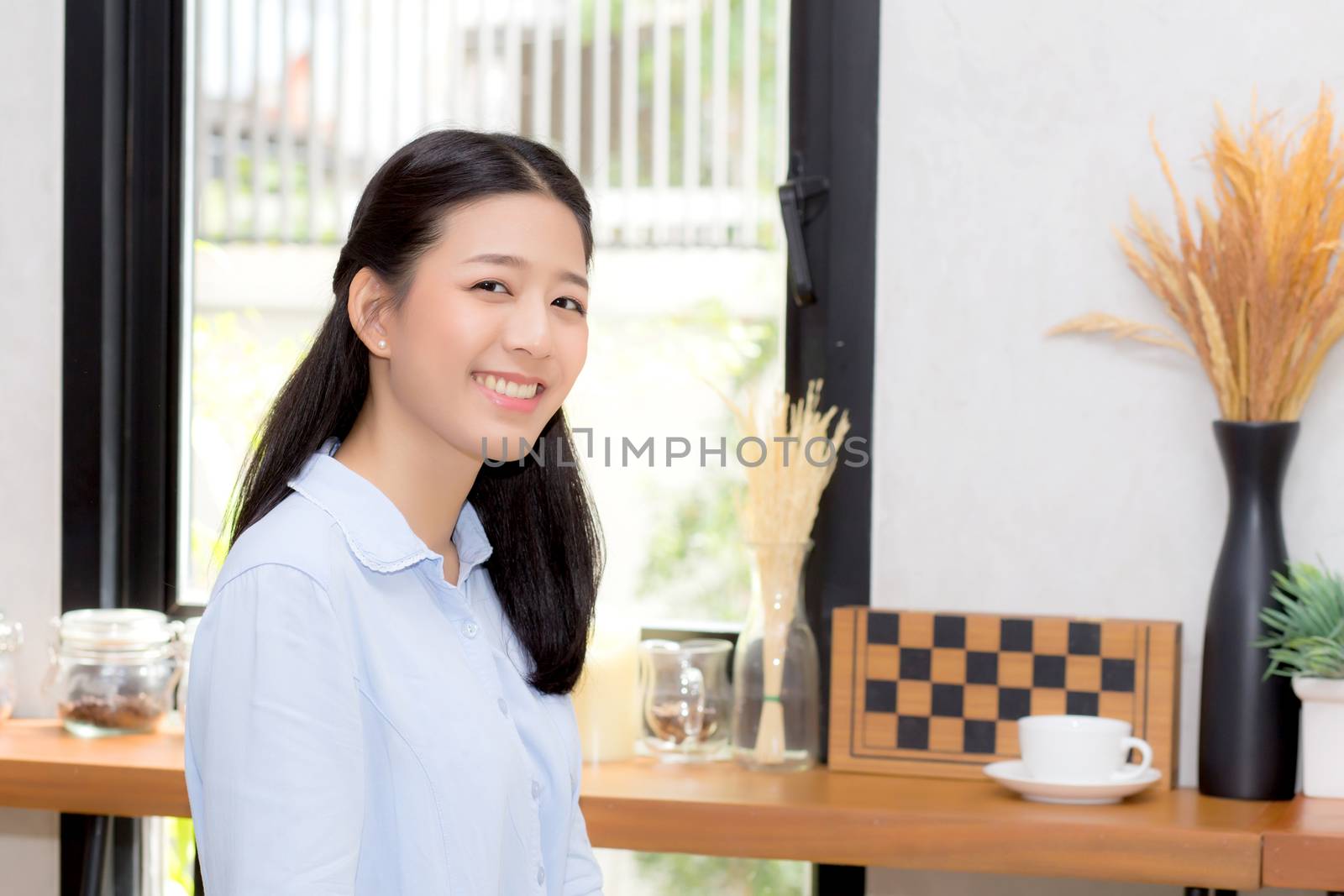 Portrait of beautiful young asian woman happiness sitting at cafe shop, businesswoman is a smile, freelance people concept.