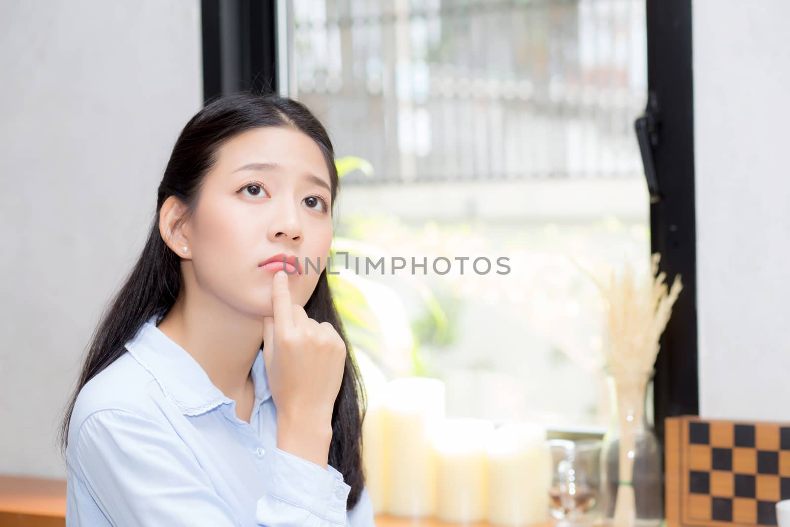 Portrait of beautiful young asian woman happiness and think sitting at cafe shop, businesswoman is a smile, freelance people concept.
