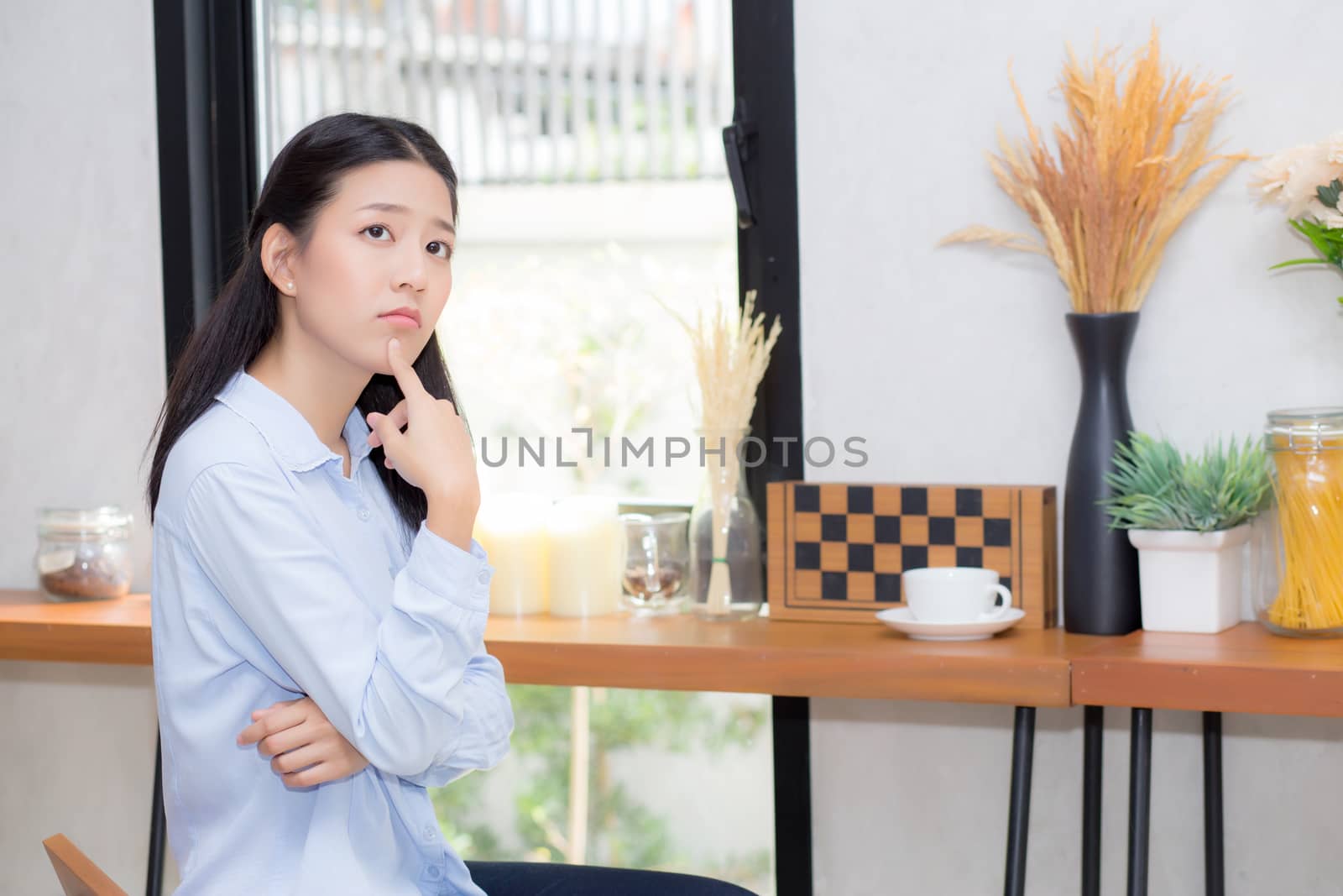 Portrait of beautiful young asian woman happiness and think sitting at cafe shop, businesswoman is a smile, freelance people concept.