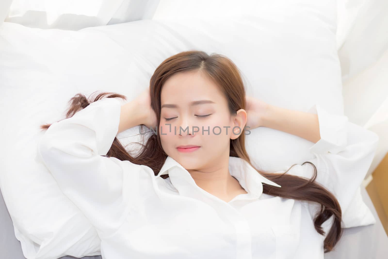 Beautiful asian young woman sleeping lying in bed with head on pillow comfortable and happy. girl with relax for health concept.