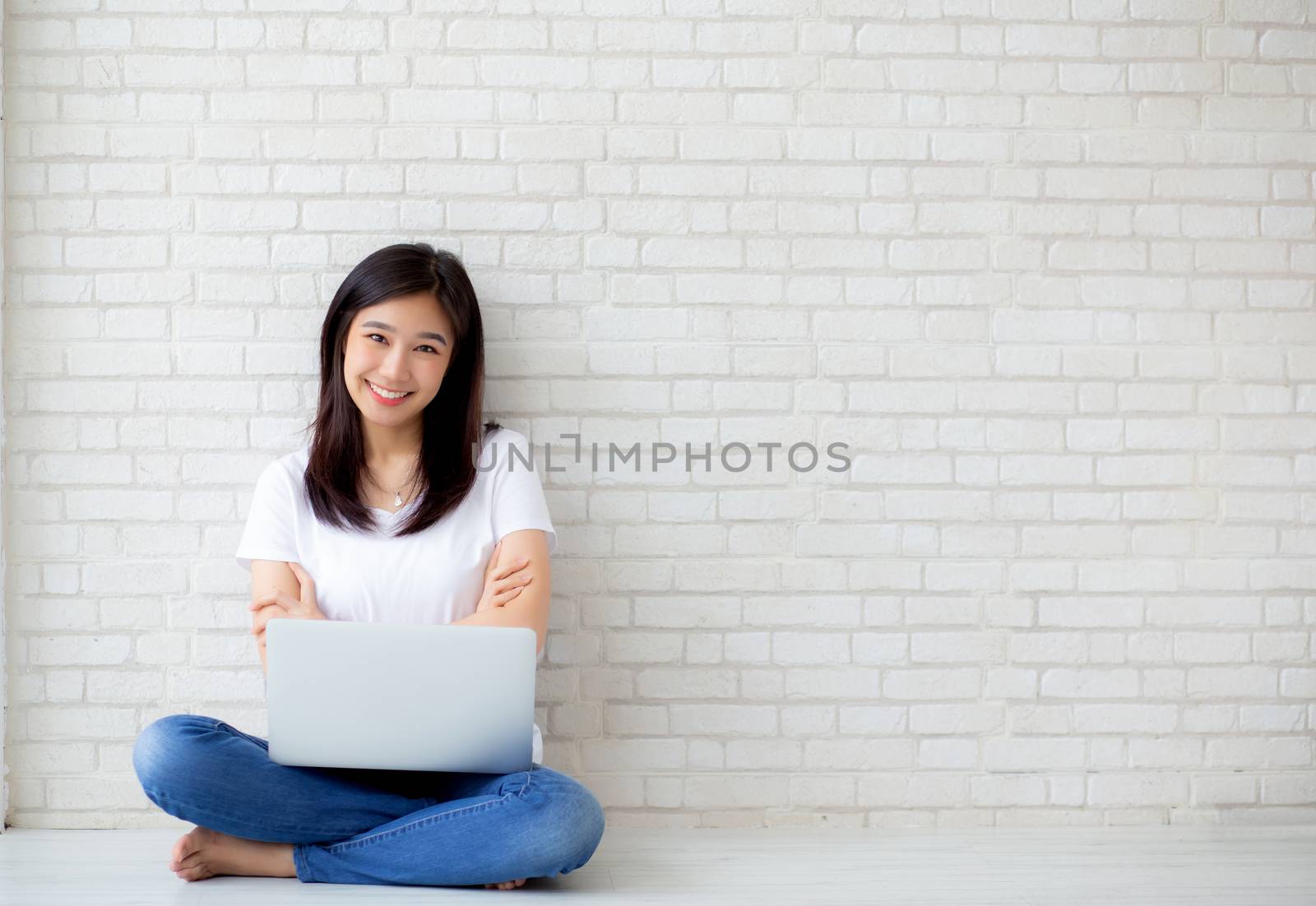 Beautiful of portrait asian young woman excited and glad of success with laptop computer, girl sitting working on cement brick background, career freelance business concept.