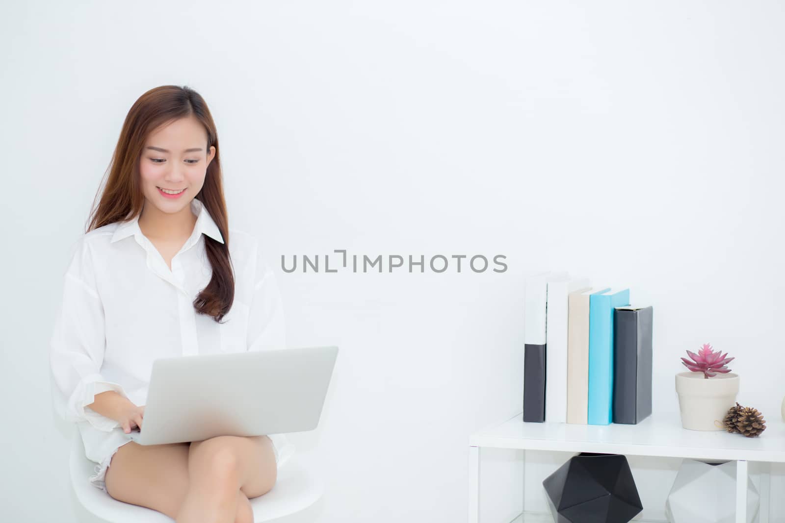 Beautiful young asian woman using laptop for leisure on sofa, girl working online with notebook freelance, communication business concept.