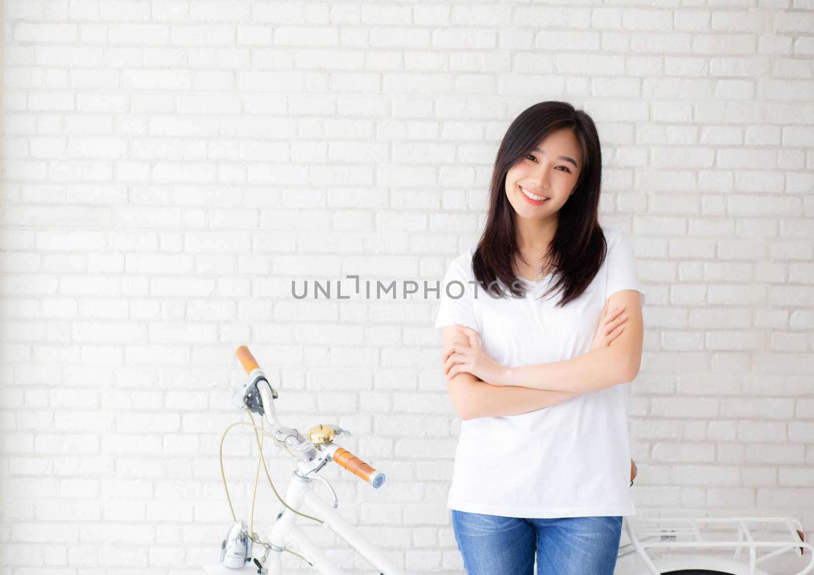 Portrait of beautiful young asian woman happiness standing on gray cement texture grunge wall brick background, businesswoman is a smiling on concrete, business people concept.