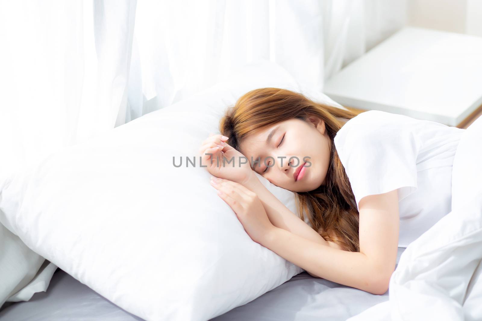 Portrait of beautiful asian young woman sleep lying in bed with head on pillow comfortable and happy with leisure, girl with relax  for health and lifestyle concept.