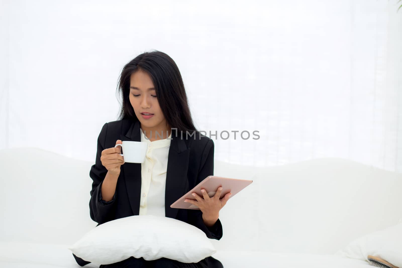 Beautiful of portrait young asian businesswoman sitting on sofa  by nnudoo