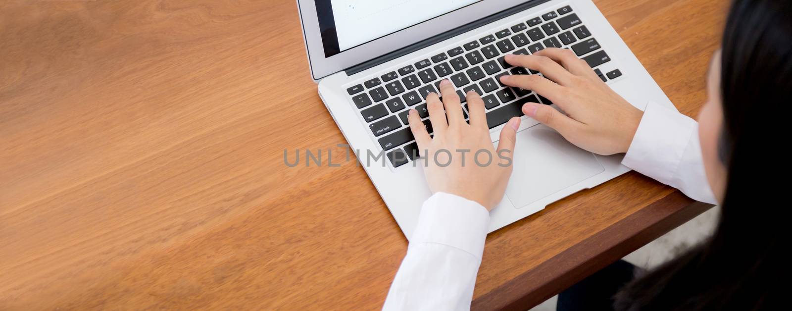 Closeup banner website business woman work with finance analysis and planing data on laptop looking graph on wood table, girl with computer statistic for success, business concept.