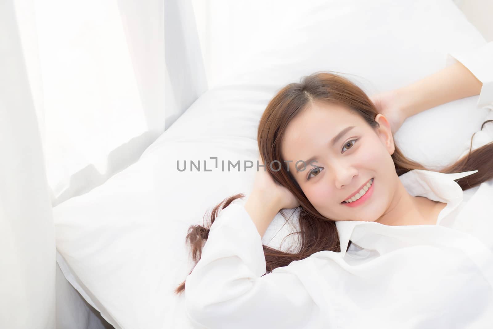 Beautiful asian young woman sleeping lying in bed with head on pillow comfortable and happy. girl with relax for health concept.
