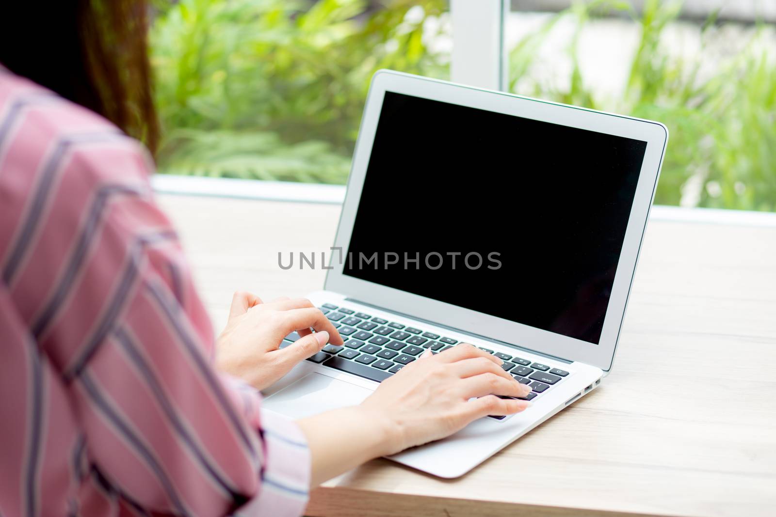 Beautiful of portrait asian young woman working online on laptop computer sitting at coffee shop, professional female freelancer using notebook with connect to internet for distance job.