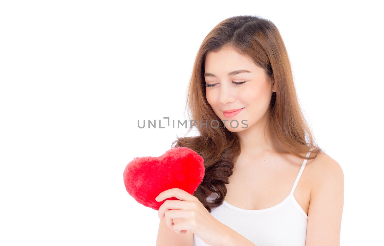 Portrait of beautiful asian young woman holding red heart shape pillow and smile isolated on white background, valentines day, holiday concept.