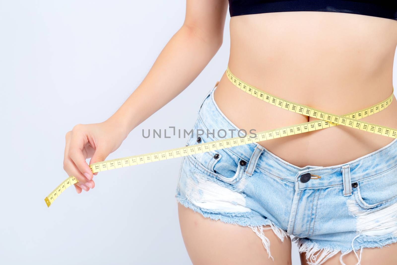 Asian woman diet and slim with measuring waist for weight isolated on white background, girl have cellulite and calories loss with tape measure, health and wellness concept.
