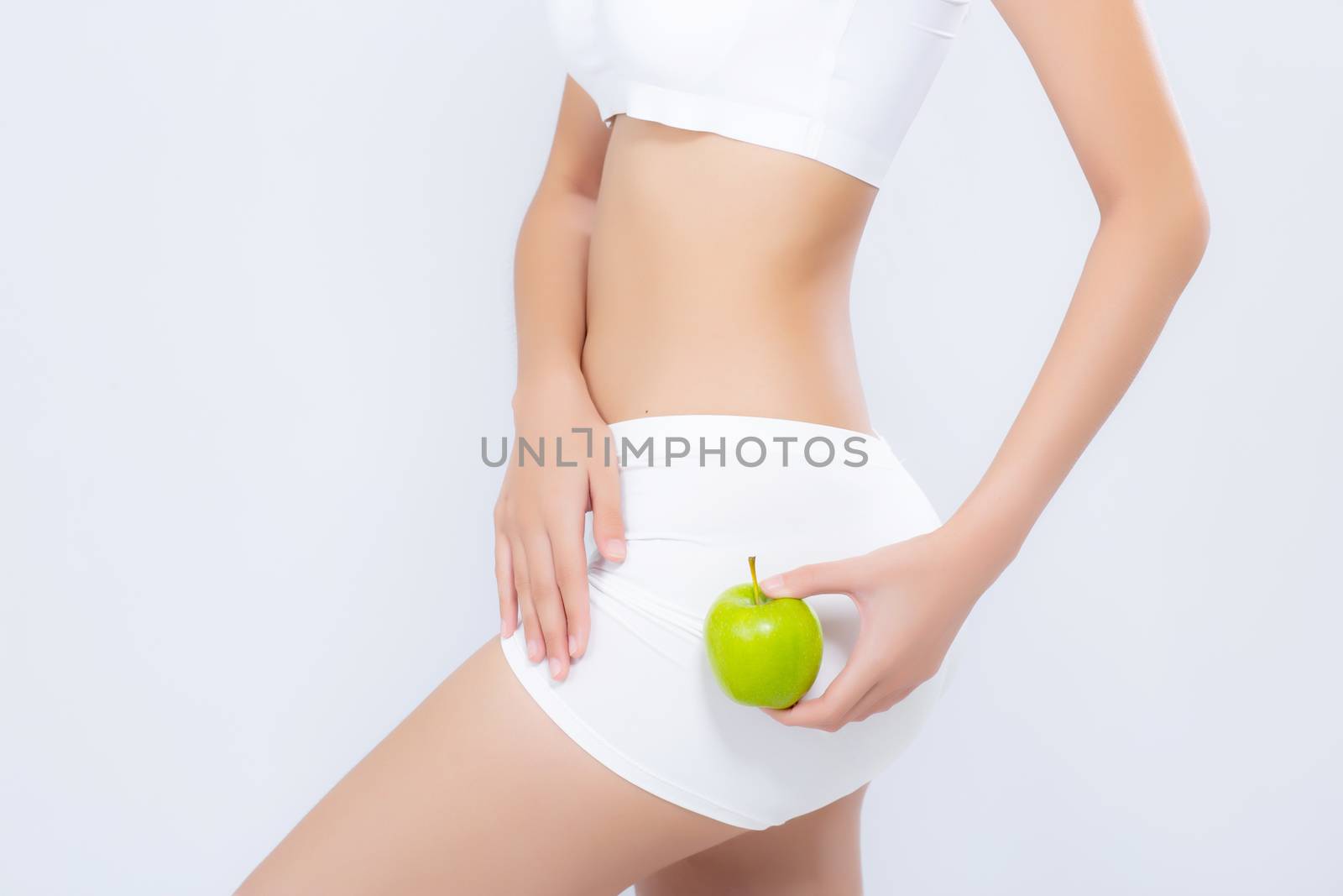 Beautiful body woman sexy slim holding green apple with cellulite, girl with fitness for weight loss and healthy isolated on white background, healthcare and diet concept.