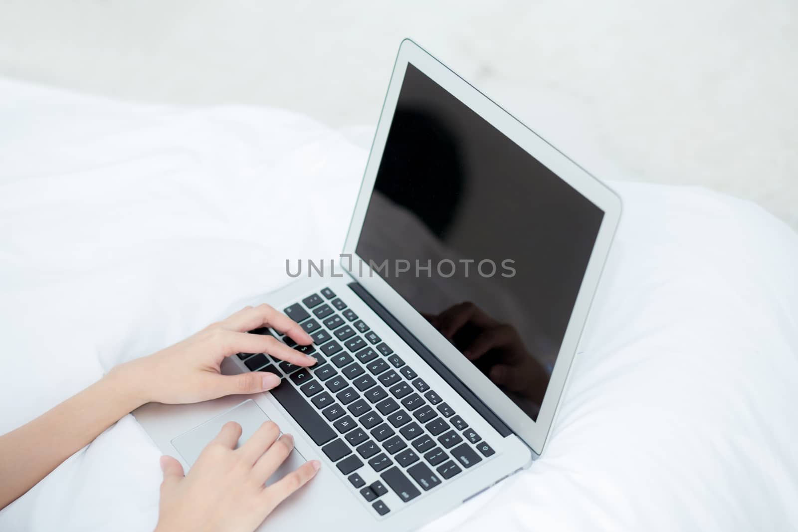 Closeup young asian woman using laptop for leisure on bedroom, girl working online with notebook freelance, business concept.