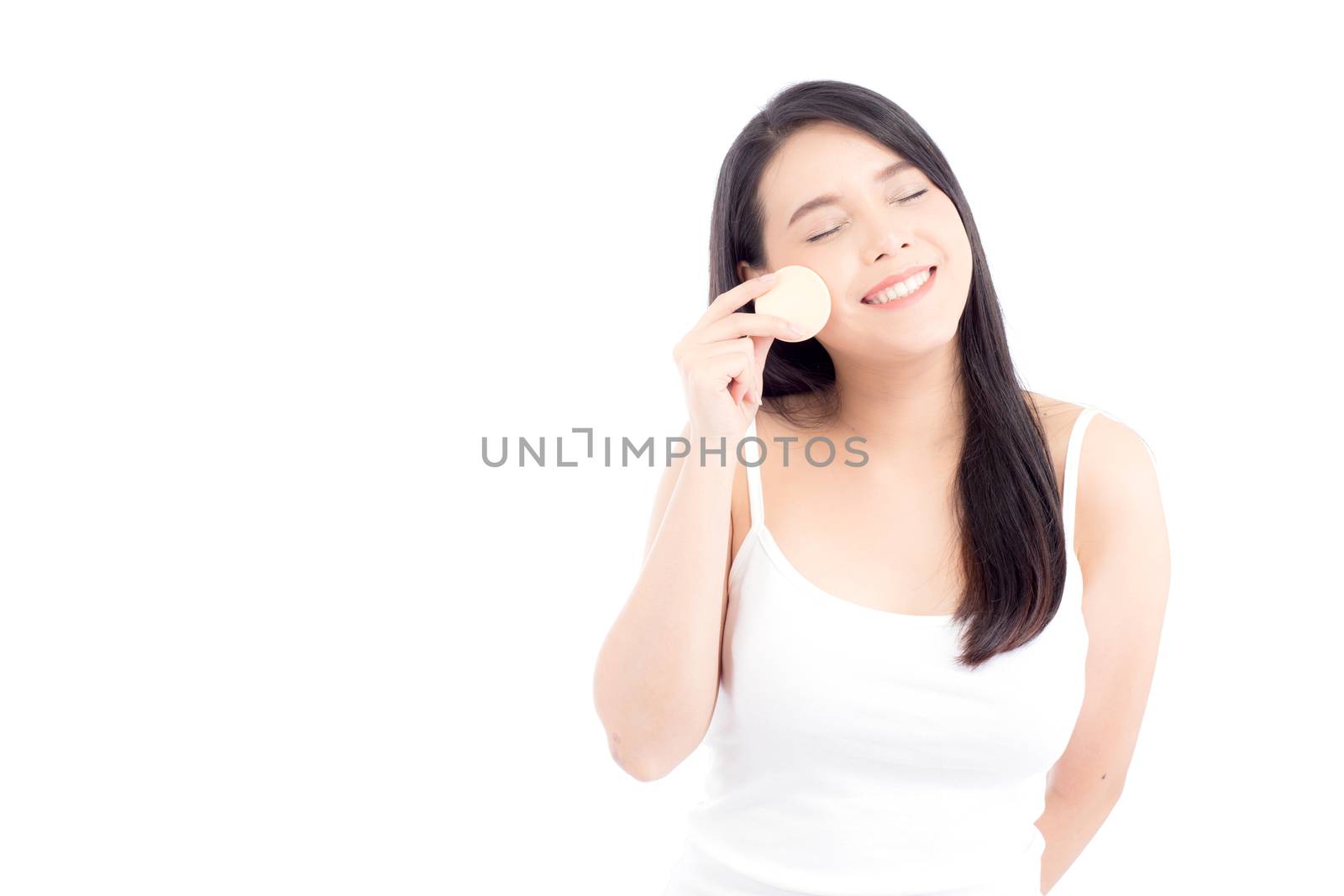 Portrait of beautiful asian woman applying powder puff at cheek makeup of cosmetic, beauty of girl with face smile isolated on white background, wellness and healthcare concept.