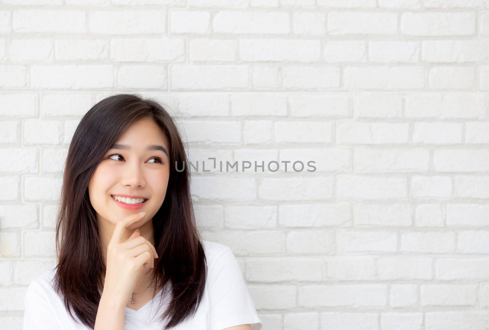 Beautiful portrait young asian woman confident thinking with cement and concrete background, girl standing expression serious or doubts with idea, lifestyle concept.