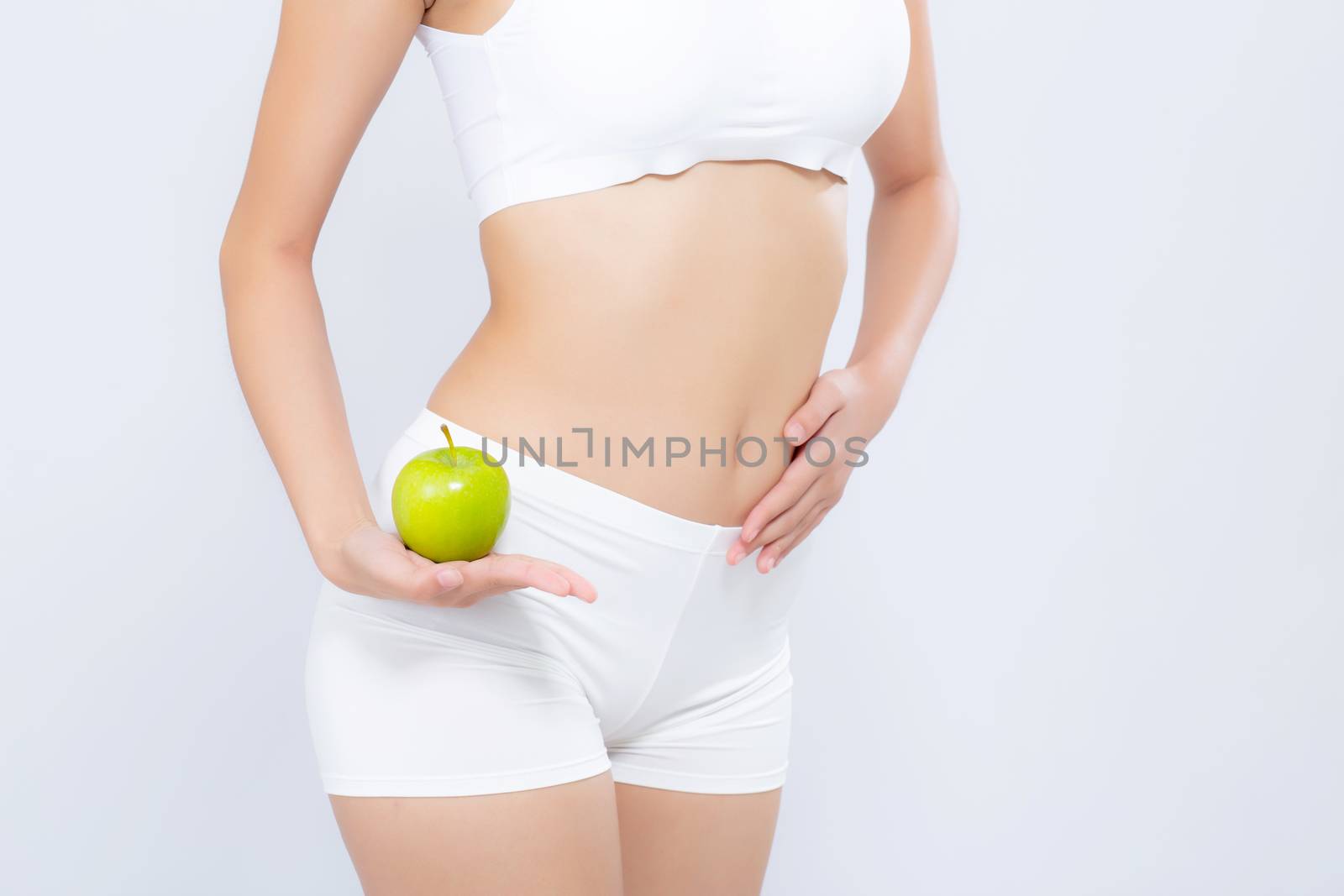 Beautiful body woman sexy slim holding green apple with cellulite for wellness, girl with fitness for weight loss and healthy isolated on white background, healthcare and diet concept.
