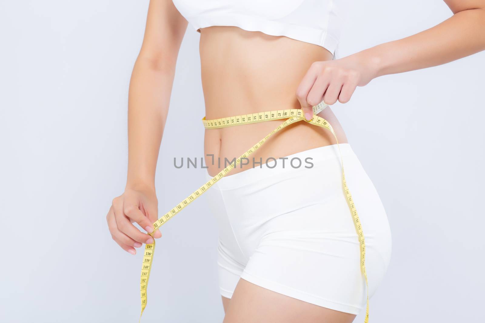 Asian woman diet and slim with measuring waist for weight isolated on white background, girl have cellulite and calories loss with tape measure, health and wellness concept.