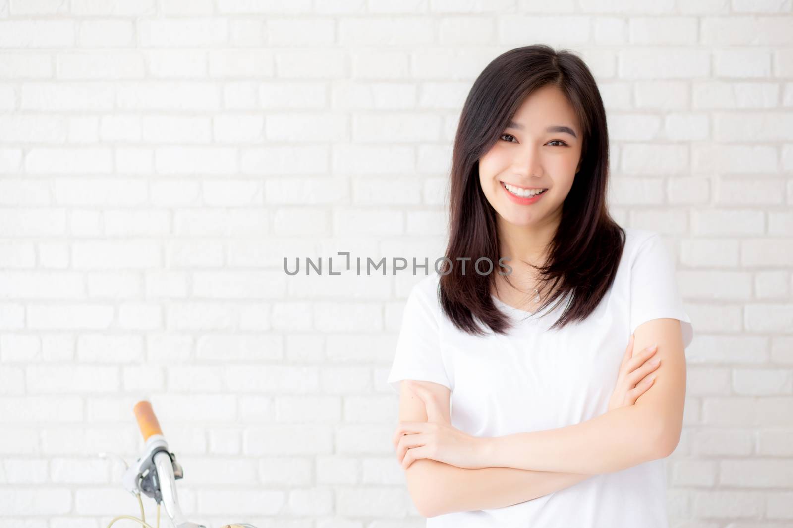 Portrait of beautiful young asian woman happiness standing on gray cement texture grunge wall brick background, businesswoman is a smiling on concrete, business people concept.