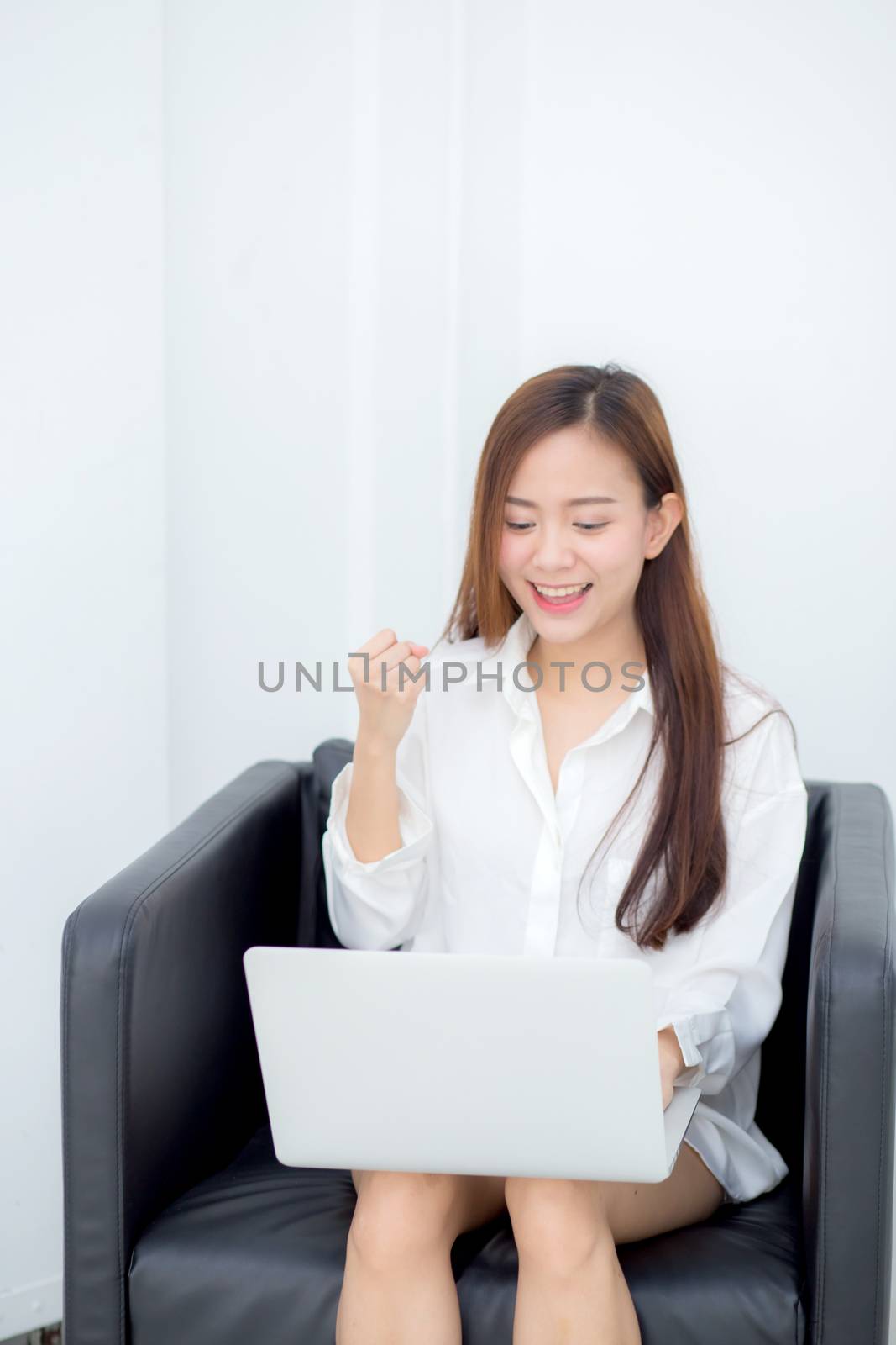 Beautiful of portrait happy young asian woman using laptop work  by nnudoo