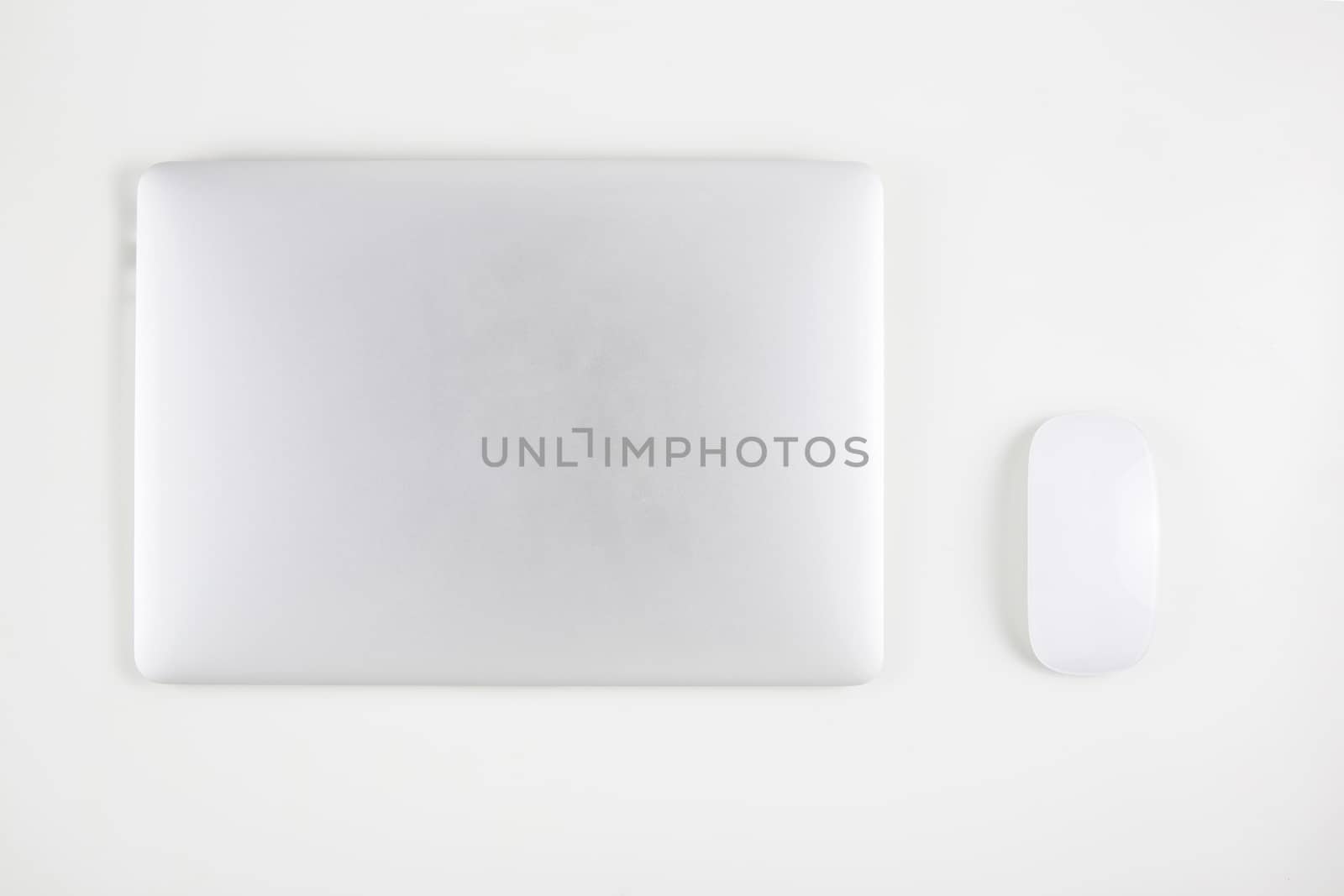 Top view of laptop computer with closed and mouse isolated on white background, notebook or netbook, communication technology concept.
