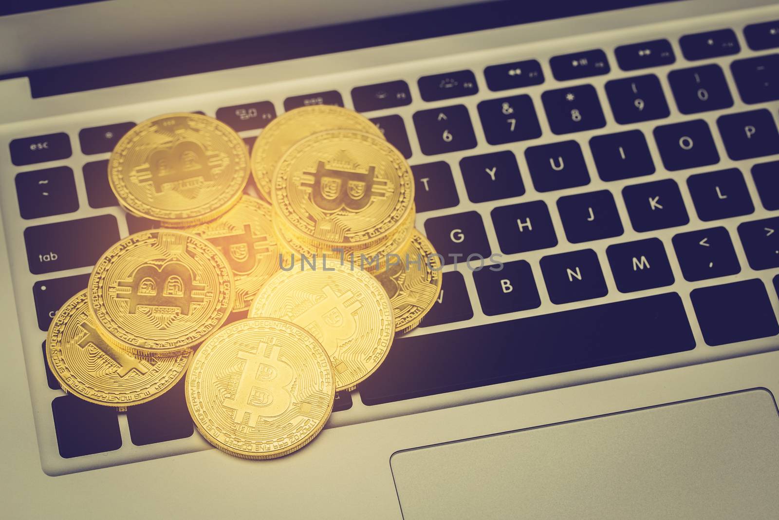 Bitcoin on laptop computer, gold coin with currency digital exchange cash with crypto, technology about money, commercial and finance concept.