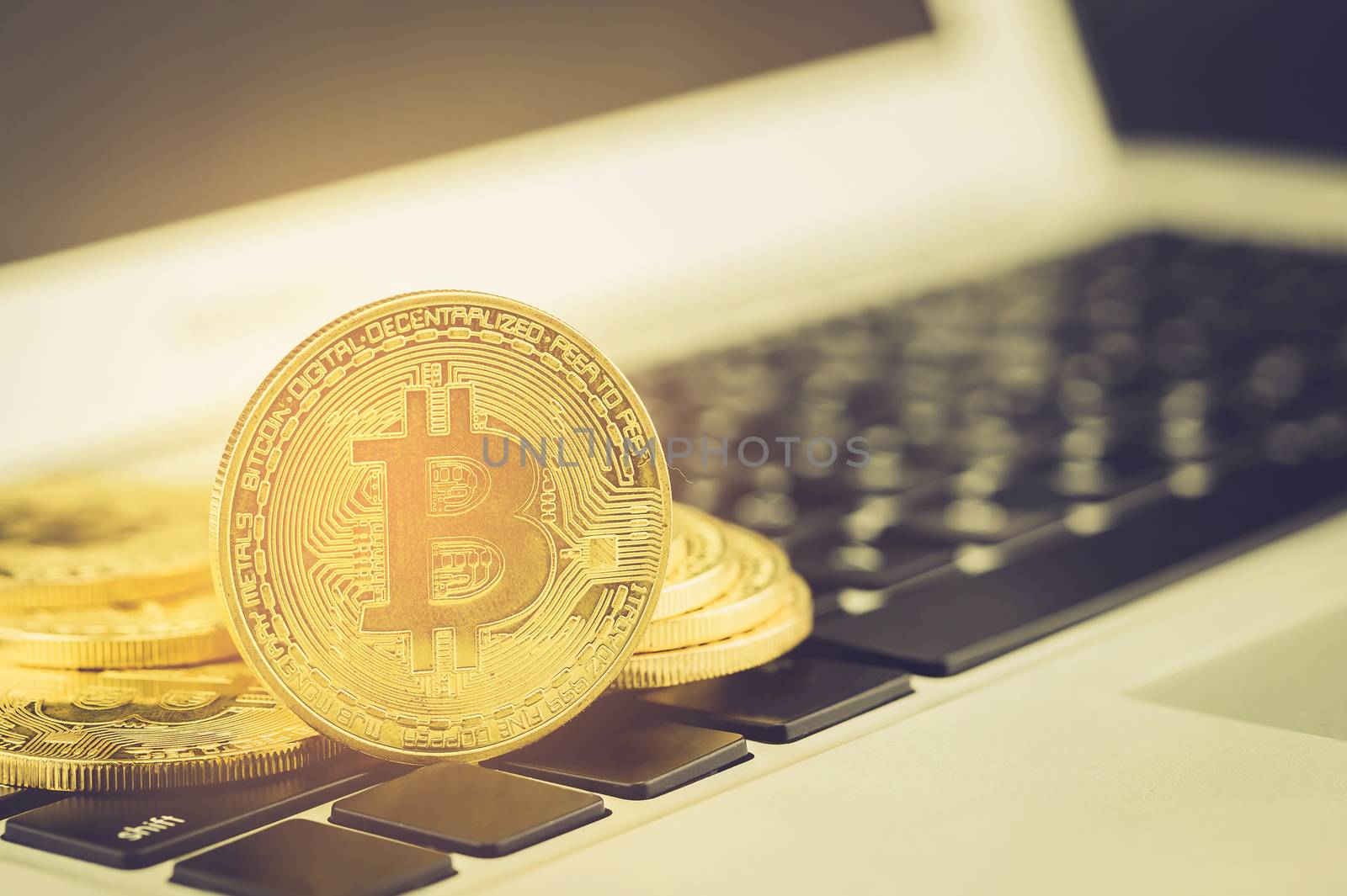 Bitcoin on laptop computer, gold coin with currency digital exchange cash with crypto, technology about money, commercial and finance concept.