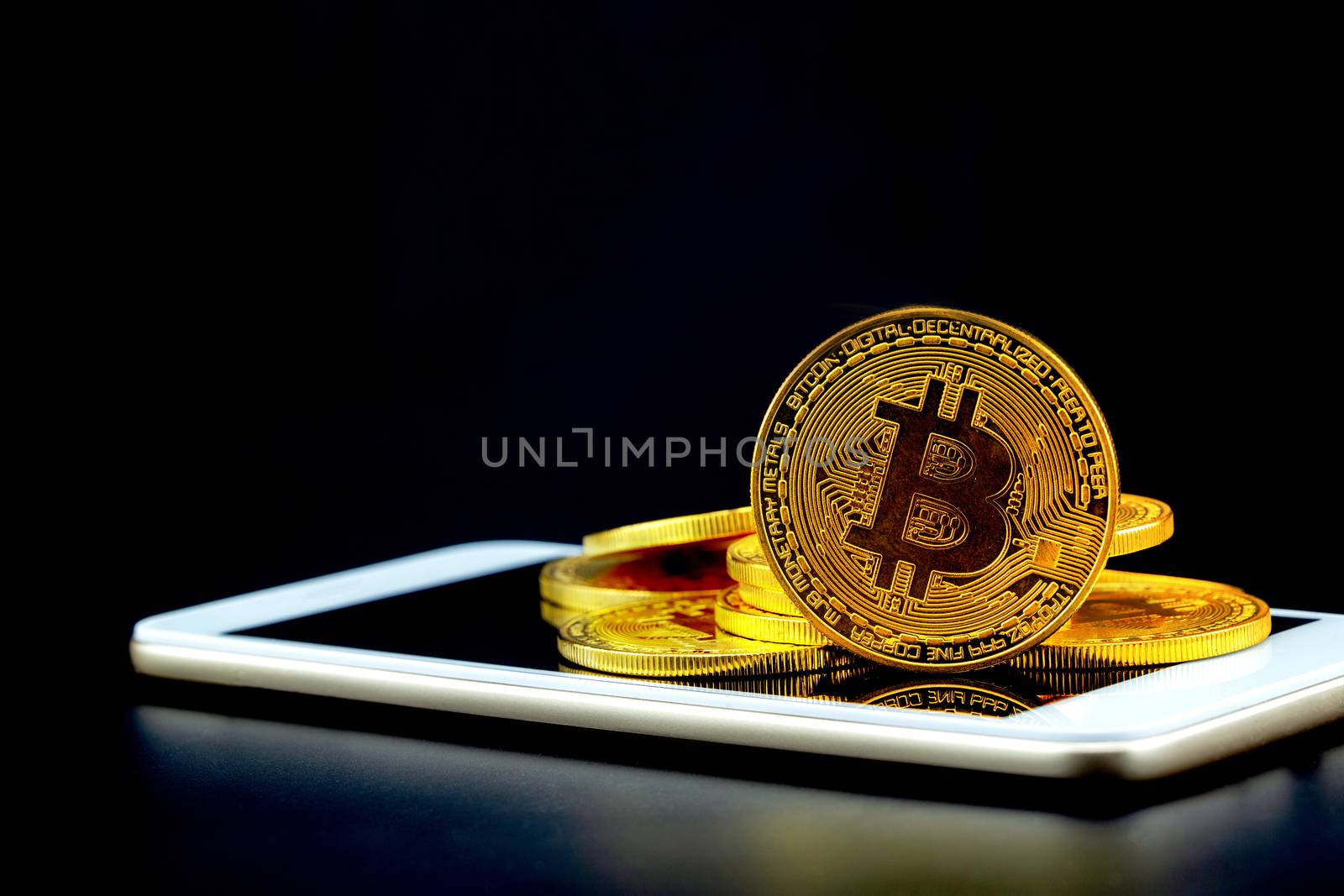 Gold bitcoin on tablet computer isolated on black background, coin money currency virtual digital exchange cash with crypto, technology finance trade, commercial business concept.