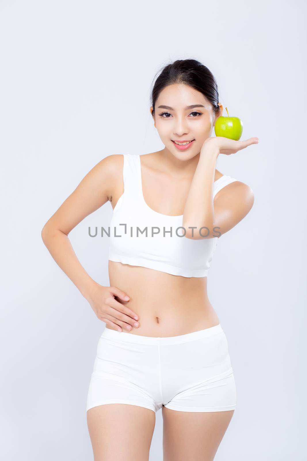 Portrait asian woman smiling holding green apple fruit and beautiful body diet with fit isolated on white background, girl weight slim with cellulite or calories, health and wellness concept.