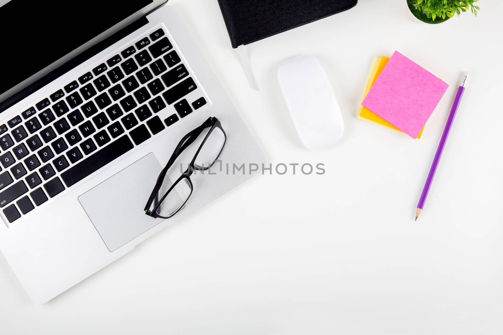 Top view of laptop computer with open display screen monitor, diary and mouse and notepad, glasses and pencil isolated on white background, notebook or netbook with keyboard, communication technology concept.