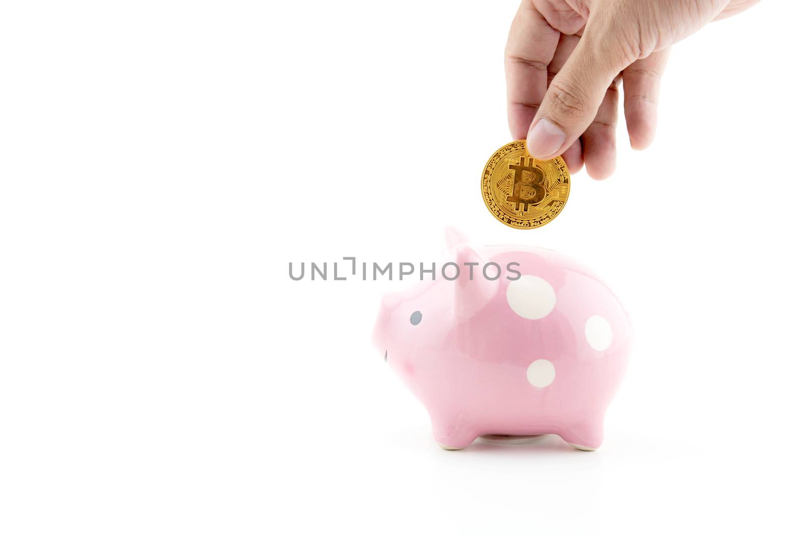 Saving golden bitcoin in piggy bank with hand isolated on white background, Digital currency money trading with cryptocurrency, coin with profit, finance concept.