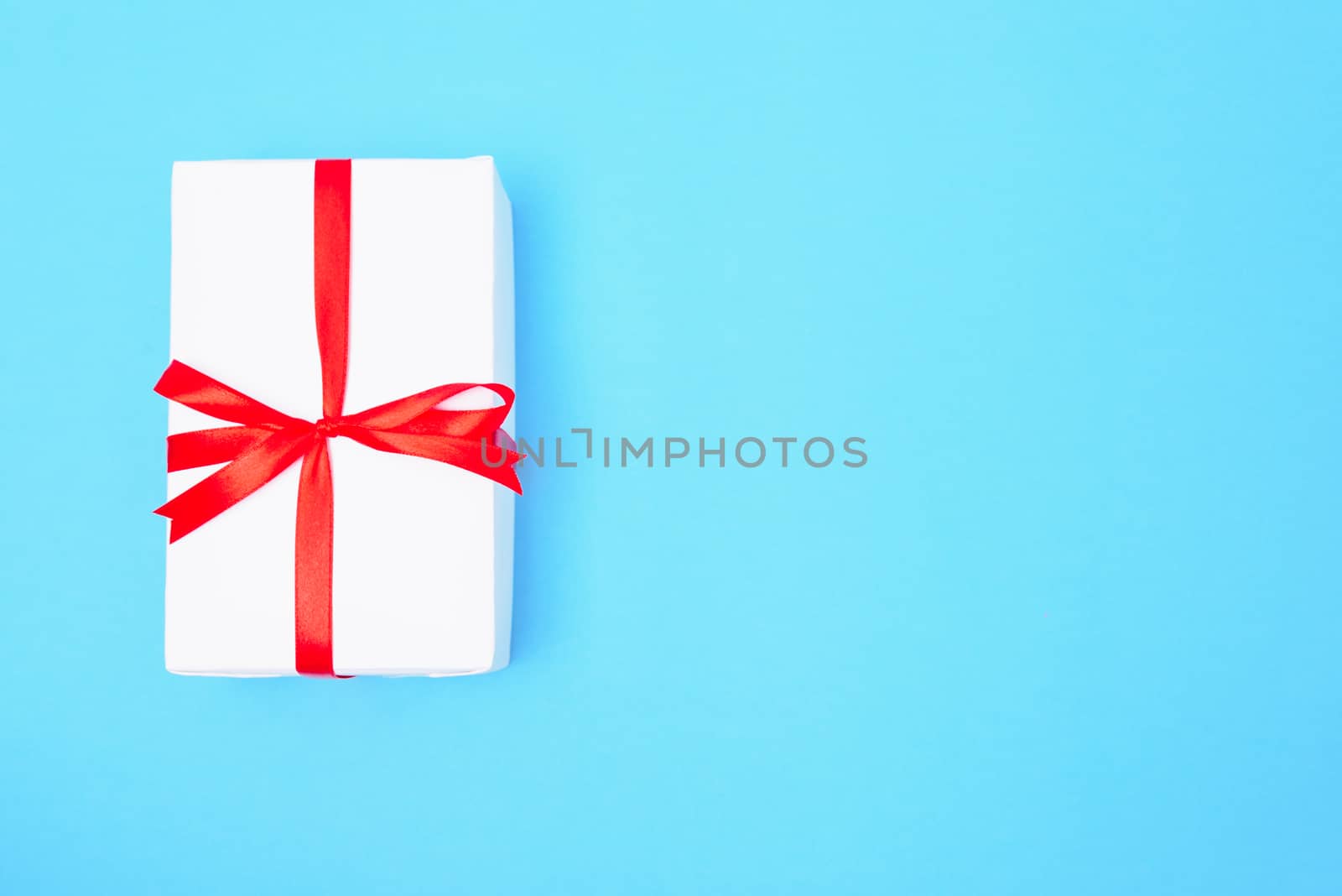 Happy New Year and Christmas 2020 or valentine day, top view craft paper wrapped present white gift box craft on blue background with copy space for your text