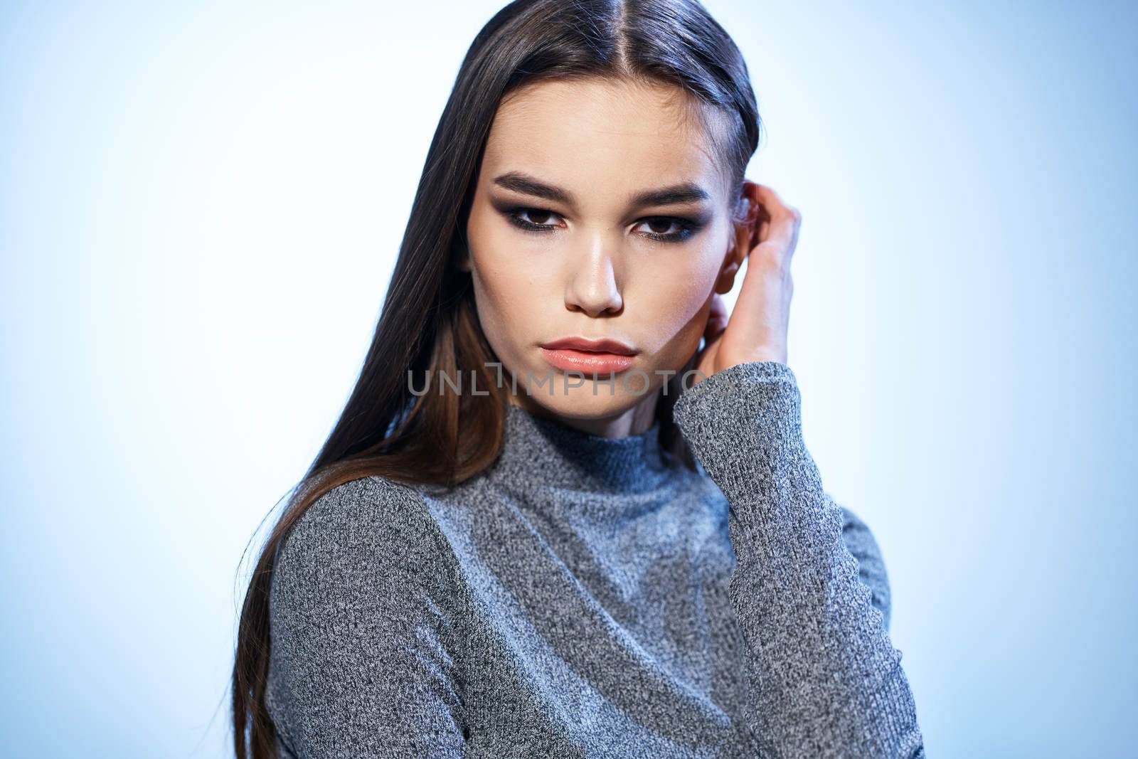 Pretty woman in gray sweater bright makeup long hair charm cropped view by SHOTPRIME