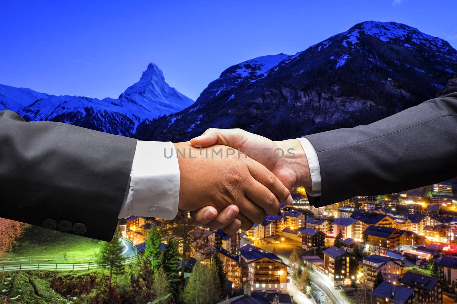 businessmen shaking hands on Zermatt, Switzerland background